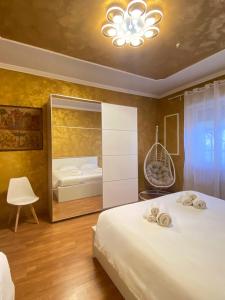 a bedroom with a large bed and a mirror at Casa Relax 120 MQ con Metro in Rome