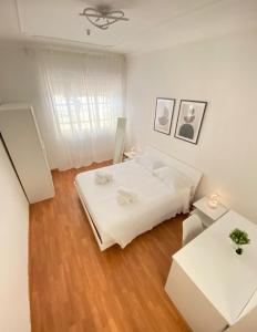 a white bedroom with a bed and two tables at Casa Relax 120 MQ con Metro in Rome