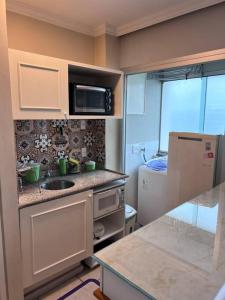 a small kitchen with a sink and a refrigerator at Apartamento Paulista in São Paulo