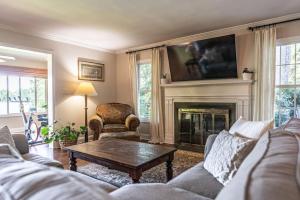 a living room with a couch and a fireplace at Sleeps 7- Whispering Pines Lake Front 