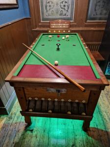 a pool table with two cue sticks on it at Railway Hotel in Faversham