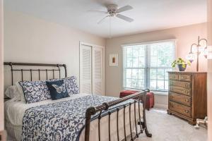 a bedroom with a bed and a ceiling fan at Sleeps 7- Whispering Pines Lake Front 
