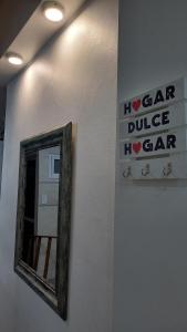 a mirror on a wall with a sign for a car garage at Sueños Del Pilar II in Godoy Cruz