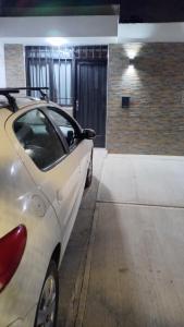 a white car parked in a parking lot at Sueños Del Pilar II in Godoy Cruz