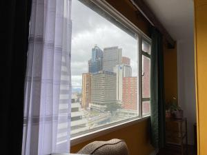 a window with a view of a city skyline at Apartamento completo centro de Bogotá in Bogotá