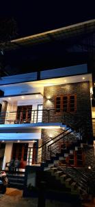 a building with stairs in front of it at night at Ceebeez homes in Ernakulam