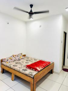 a bed in a room with a ceiling fan at Ghanshyam hotel in Dwarka