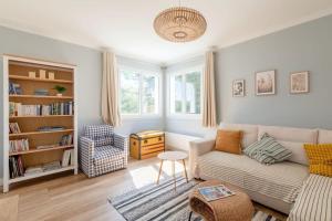 a living room with a couch and a chair at Charmante maison à 100M de la plage in Pornic