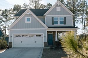 a gray house with a white garage at Sleeps 9- In Whispering Pines in Carthage