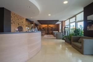 a lobby with a bar with couches and plants at Sanlu Hotel in Serrano +96 photos