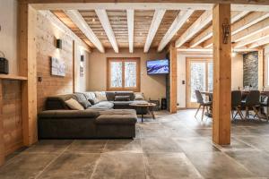 a living room with a couch and a table at Alpen Chalet in Morzine