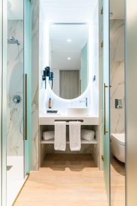 a bathroom with a sink and a mirror at Hotel Málaga Vibes in Málaga