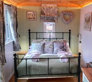 a bedroom with a bed with pillows on it at The Little Mill Inn in New Mills