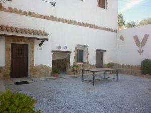 a patio with a table in front of a building at Alojamiento Rural LA TEJA in Cortes de Baza