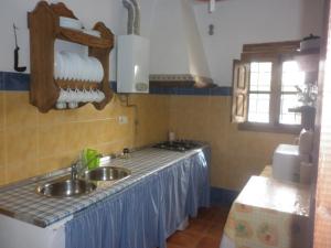 a kitchen with a sink and a counter top at Alojamiento Rural LA TEJA in Cortes de Baza
