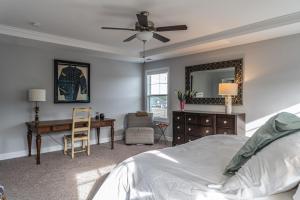 a bedroom with a bed and a desk and a mirror at Sleeps 8- In Whispering Pines 