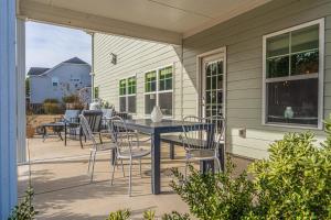 a patio with a table and chairs on a house at Sleeps 8- In Whispering Pines 