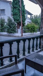 a black fence with a bench and a building at Luxury apartment in the city center in Tírnavos