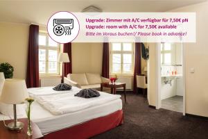 una camera d'albergo con letto e divano di SchlafGut AppartementHotel a Lipsia