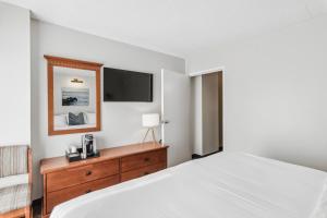 里霍伯斯灘的住宿－Cape Suites Room 5 -Free Parking! Hotel Room，卧室配有一张床,墙上配有电视。