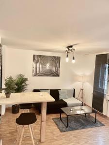 a living room with a couch and a table at appartement Montreux centre lac in Montreux