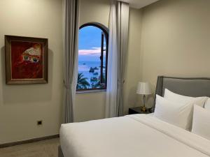 a bedroom with a large bed and a window at CASEPIA - Free Hon Thom Cable Car & Aquatopia Water Park in Phu Quoc