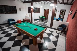 a pool table in the middle of a room at Alameda Galu in Atibaia