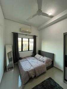 a bedroom with a large bed with a window at Khisya homestay in Kampong Soi