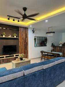 a living room with a blue couch and a table at Khisya homestay in Kampong Soi
