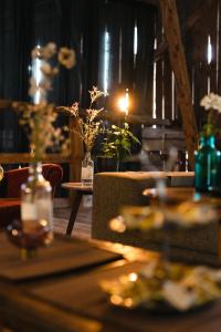 a table in a restaurant with two tables and flowers at Glamping in Småland in Eksjö