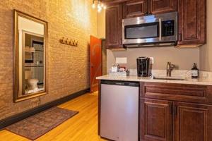 a kitchen with a sink and a microwave at Hip Urban Loft-Small Town Charm-124 LOFTS #2 in West Dundee