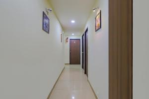 a corridor of a hospital with a door at Collection O Greenwood in Ahmedabad