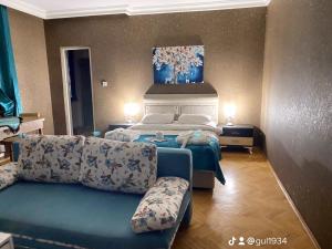a hotel room with a bed and a couch at GÜL APART SUİT in Istanbul