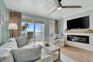 a living room with a couch and a tv at Oceans Pointe Nantucket inspired condo on the bay in Tampa