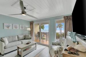 a living room with a couch and a table at Oceans Pointe Nantucket inspired condo on the bay in Tampa