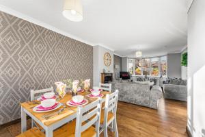 a dining room and living room with a table and chairs at Stylish Nottingham House - Parking - Garden in Nottingham