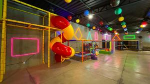 a play room with a playground with a slide at Hotel Dolce Dulce in Olímpia