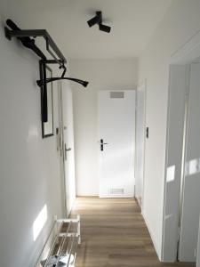 a hallway with a white door and a stairway at City - Apartment Weststadt in Karlsruhe