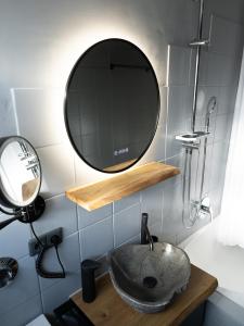 a bathroom with a sink and a mirror at City - Apartment Weststadt in Karlsruhe