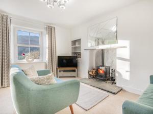 a living room with a couch and a fireplace at 2 Bed in Glenridding SZ178 in Glenridding