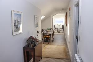 a hallway with a table and a dining room at Lakeview Retreat in Portroe