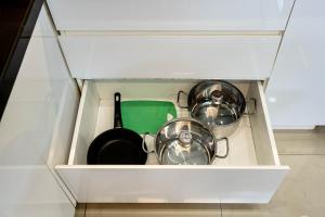two pots and pans in a drawer of a kitchen at We Home Ben Thanh in Ho Chi Minh City