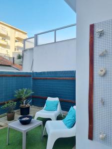 a patio with two chairs and a table at Honey House in Matosinhos