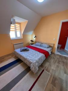 Гостевой Отель-125 في أكتاو: غرفة نوم بسرير كبير مع بطانية حمراء