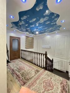 a room with a blue ceiling with clouds at Ak-Orgo guest house in Bishkek