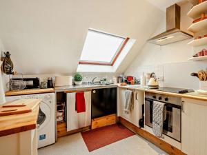 a kitchen with a sink and a dishwasher at 1 Bed in Kinghorn 47388 in Kinghorn