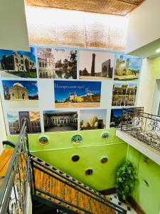a jacuzzi tub in a building with pictures on the wall at Hotel Uncle Kolya Boutique in Bukhara