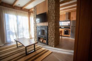 a living room with a table and a fireplace at Explora la magia de San Martín de los Andes in San Martín de los Andes