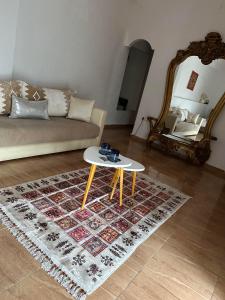 a living room with a couch and a table at Riad Ras Lafaa in Safi