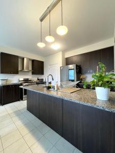 a kitchen with dark wood cabinets and a counter top at Niagara Falls BNB 15 mins away from Falls in Thorold